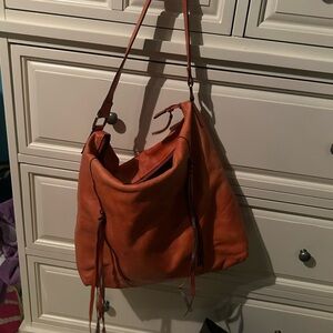 Kiko orange shoulder bag with front zipper pockets. Saddle bag. Soft leather